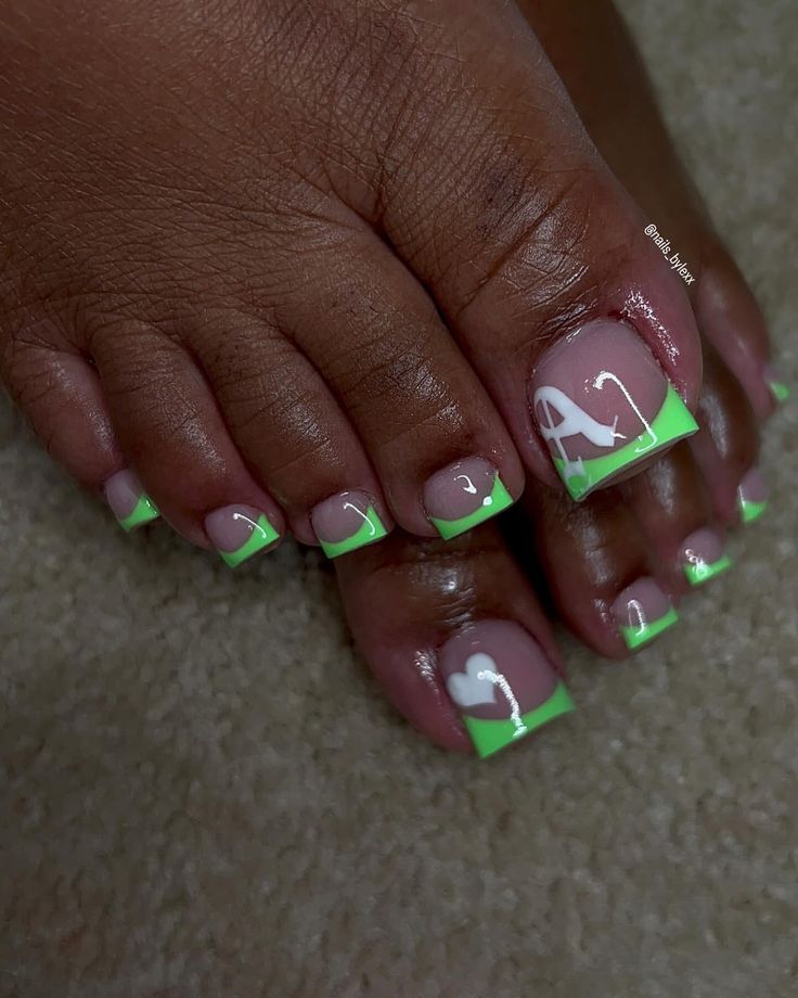 Trendy Pastel Pink and Vibrant Green Pedicure with Heart Motif and Playful Accents.