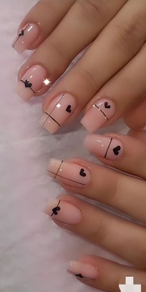 Elegant Chic Nail Design: Soft Nude Base with Black Heart Accents and Sophisticated Fine Lines.