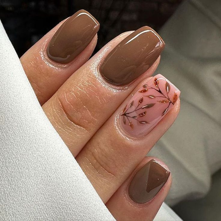 Elegant Rich Brown Nail Design with Floral Accents and Glossy Gold Highlights.