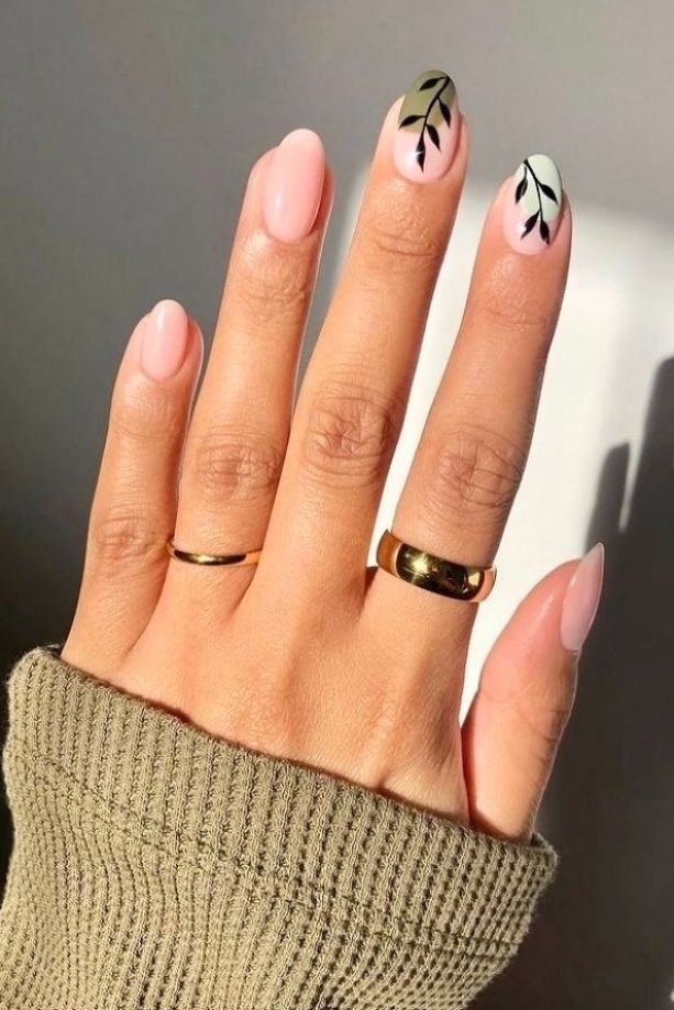 Elegant Soft Pink Nail Design with Leaf Motifs and Gold Accents