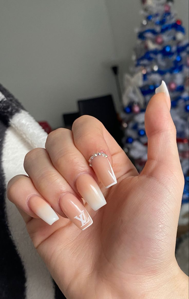 Chic Nude Gradient Nails with White Tips and Glamorous Rhinestone Accent.