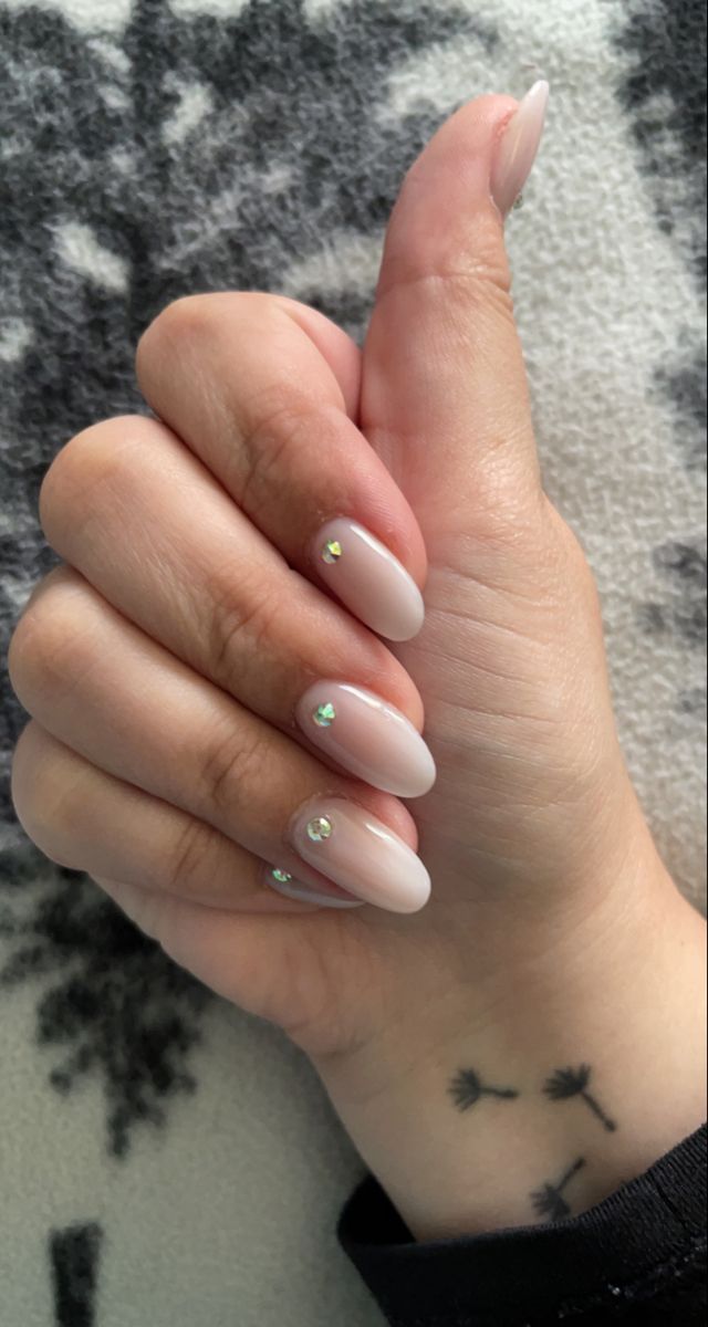 Chic Almond-Shaped Nails with Nude Polish and Sparkling Rhinestones for Versatile Glamour.