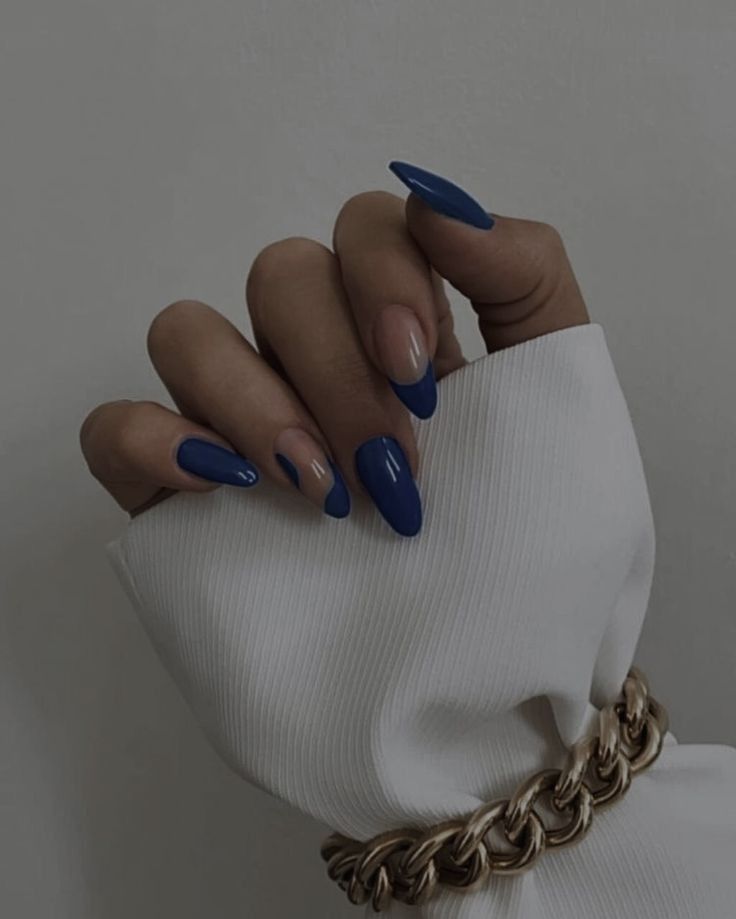 Elegant Almond-Shaped Manicure in Deep Blue and Nude with Modern Accessories.