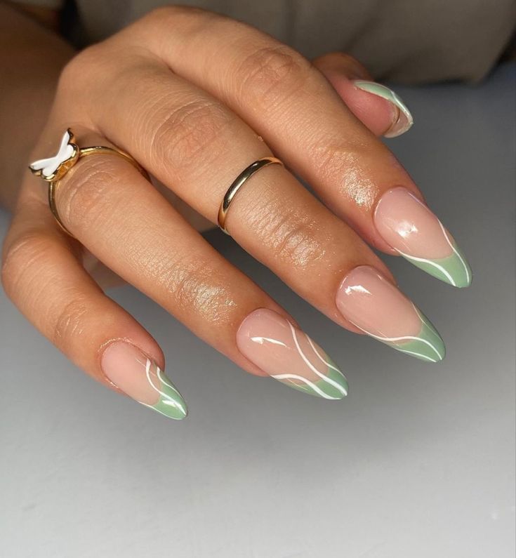 Elegant Mint Green French Tip Almond-Shaped Nails with Glamorous Gold Rings.