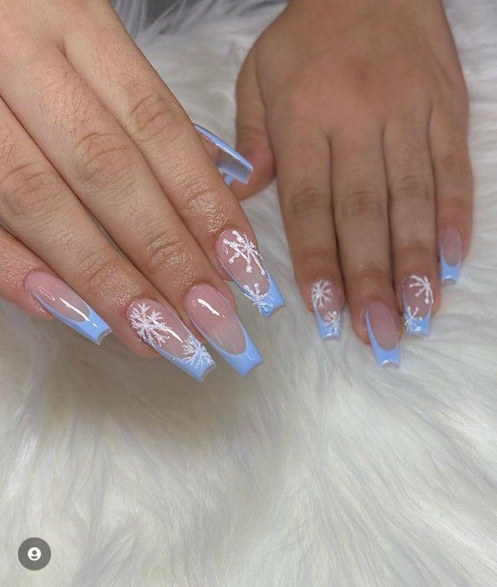 Elegant Winter Nail Design: Pastel Blue Tips & Intricate Snowflake Patterns