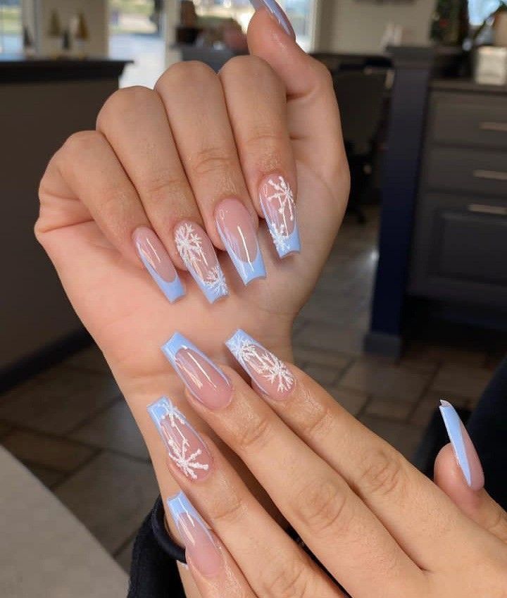 Chic Winter-Inspired Nail Design with Soft Blue Gradient and Snowflake Patterns