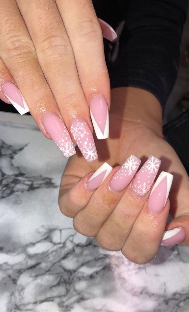 Chic Winter Nail Design: Soft Pink and Crisp White with Whimsical Snowflake Patterns.