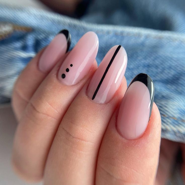 Sophisticated Elegant Nail Design: Soft Pink Base with Modern Black Accents and Playful Dots.