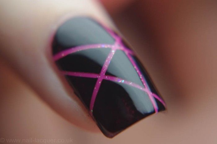 Chic Modern Nail Design: Glossy Black Base with Bold Pink Geometric Lines.