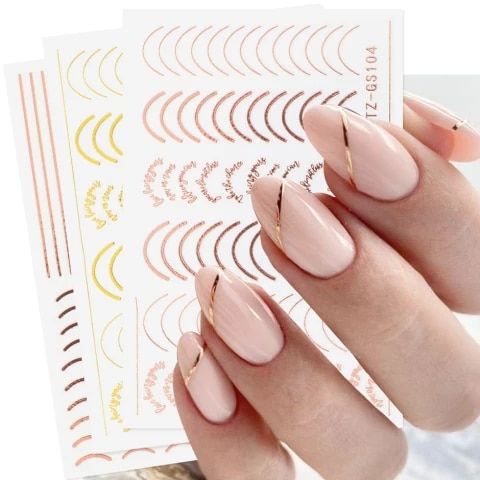 Elegant Nude Nail Design with Chic Golden Accents and Minimalist Patterns.