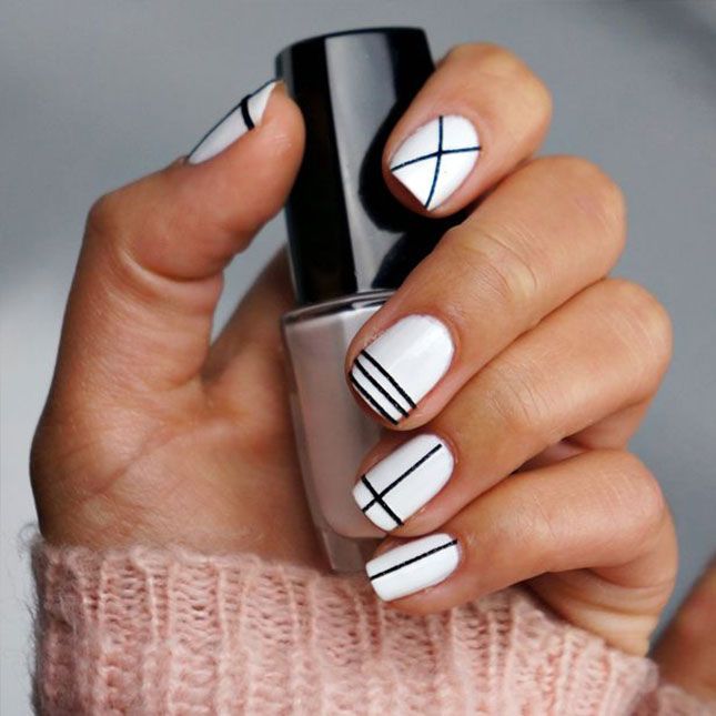 Elegant Minimalist Nail Design: White Base with Black Geometric Accents