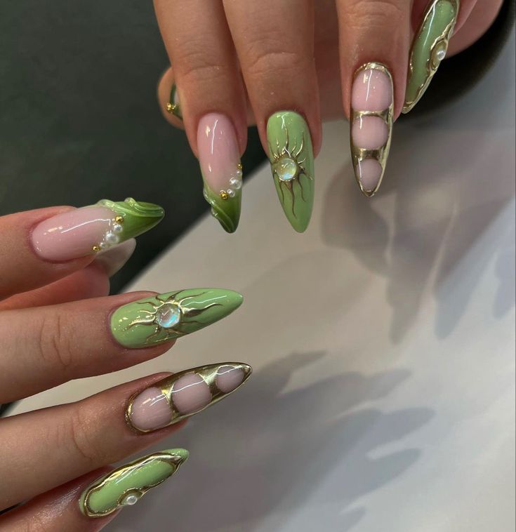 Trendy Pastel Pink and Soft Green Nail Design with Intricate Details and Gold Accents.