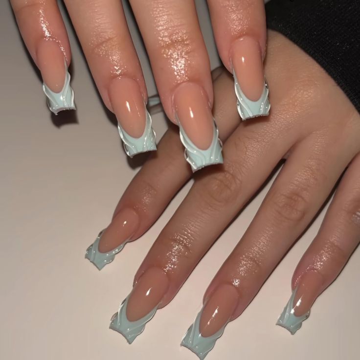 Elegant Nude and Pastel Blue Nail Design with Glossy Finish and Wavy Edges.