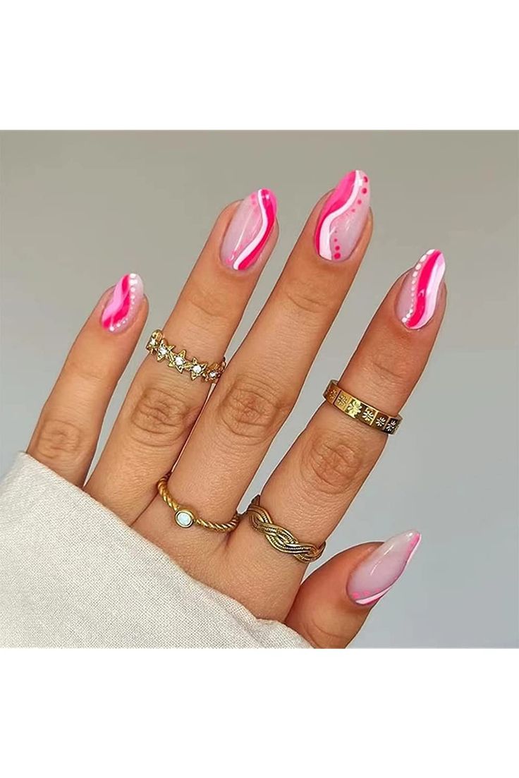 Elegant Soft Pink and White Nail Design with Chic Accents and Delicate Rings.