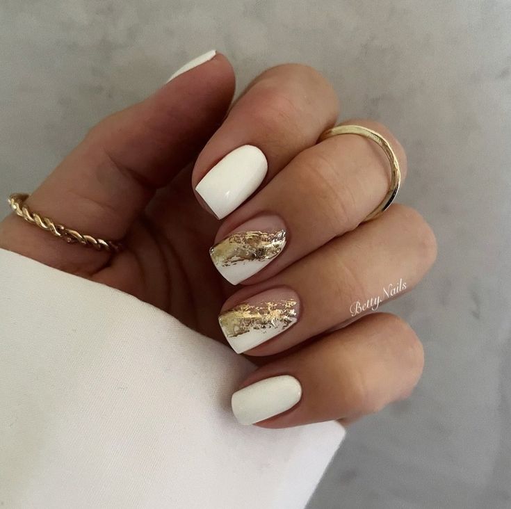 Sophisticated White Nail Design with Chic Gold Accents for Any Occasion.