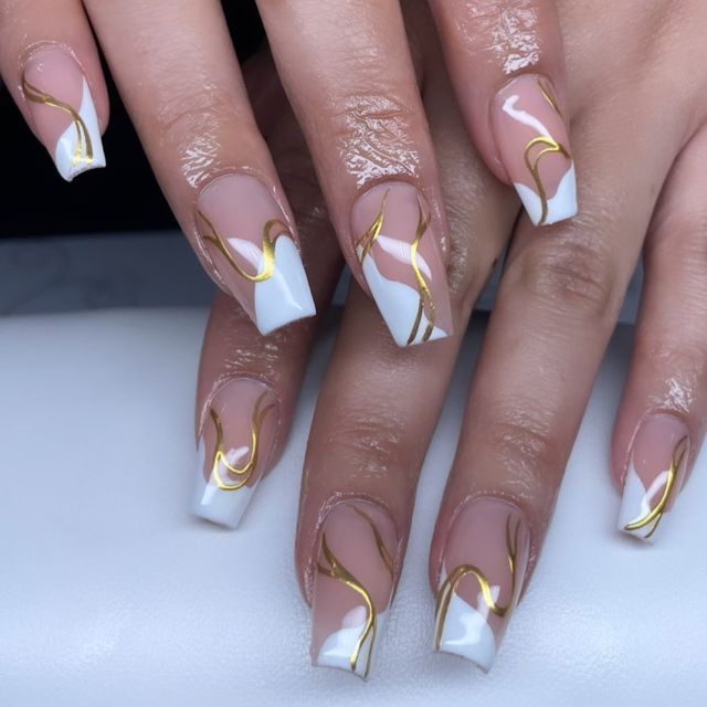 Chic Nail Design: Glossy White and Nude with Glamorous Gold Accents