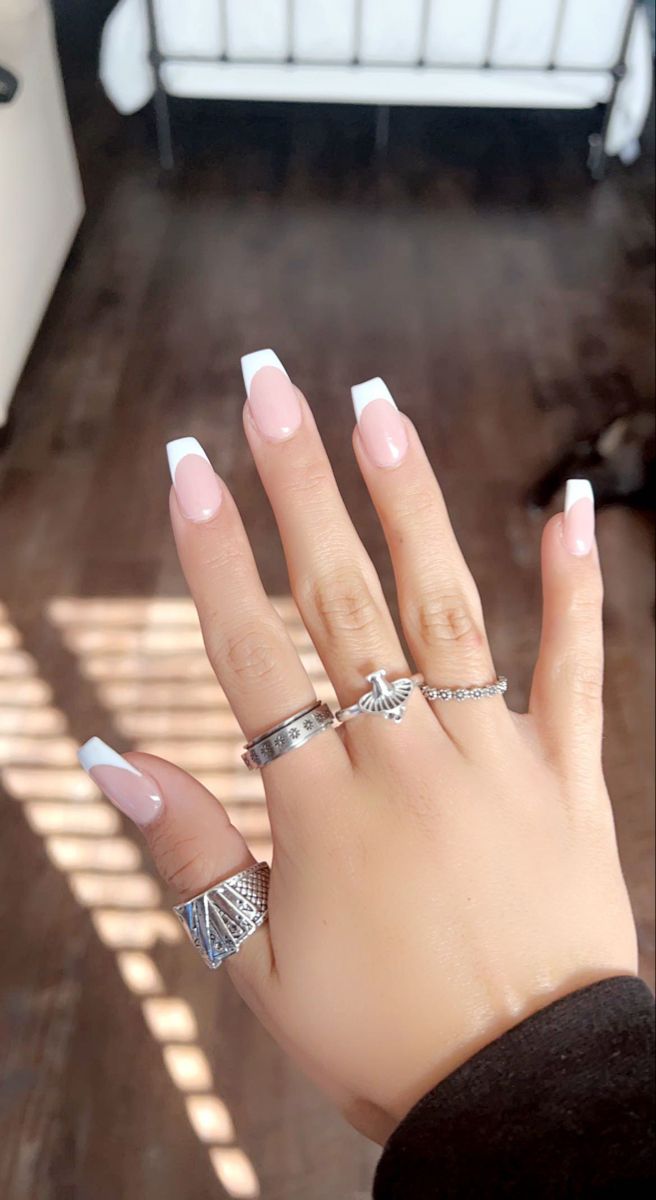 Sophisticated French Tip Nails with Soft Nude Base and Silver Rings.