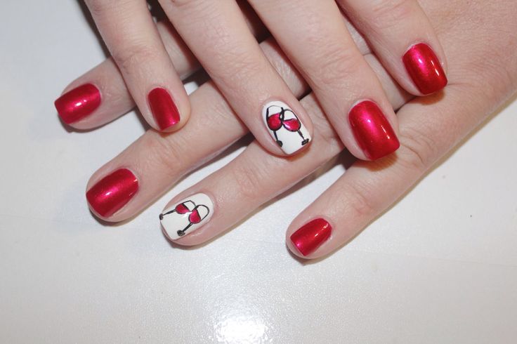 Charming Glossy Red Nail Design with Whimsical Cherry Accent.