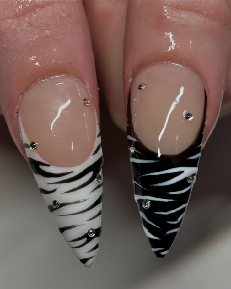 Bold Zebra Print Stiletto Nails with Glamorous Rhinestones Showcase Individuality and Style.