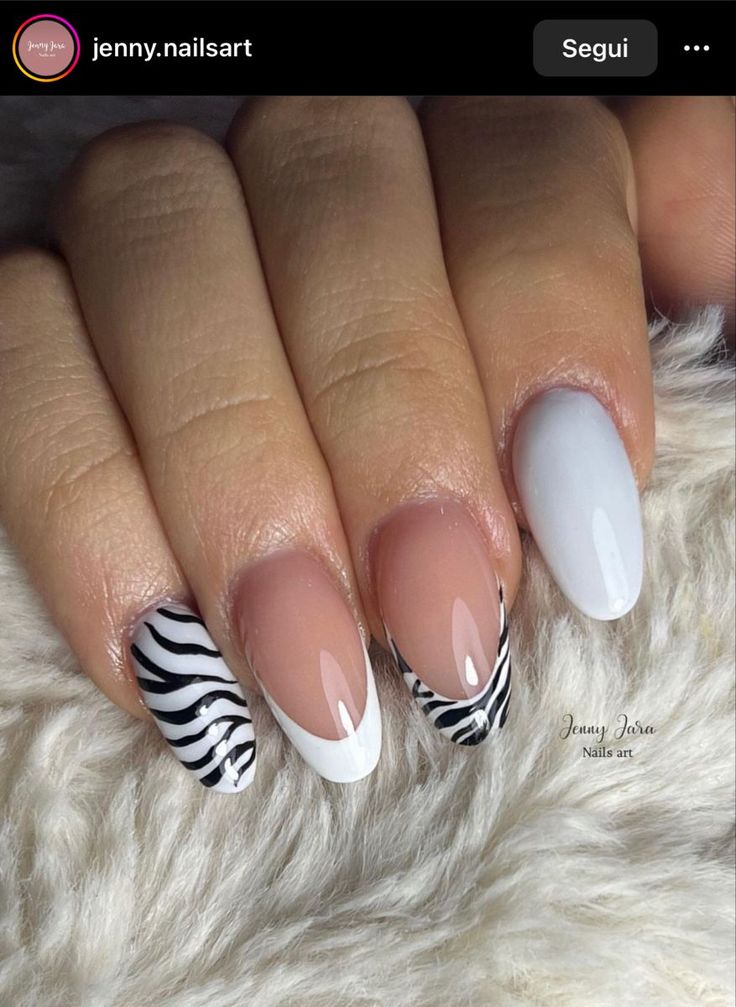 Chic Nail Design: Elegant Blend of Glossy Nude, Sleek White, and Bold Zebra Stripes.