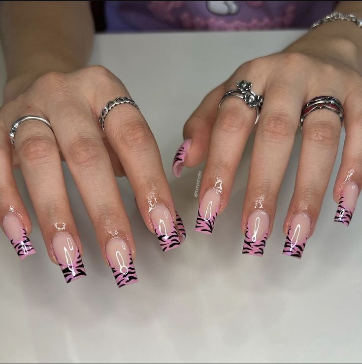 Chic Elongated Acrylic Nails: Soft Pink Base with Bold Zebra Stripes and Silver Accents.