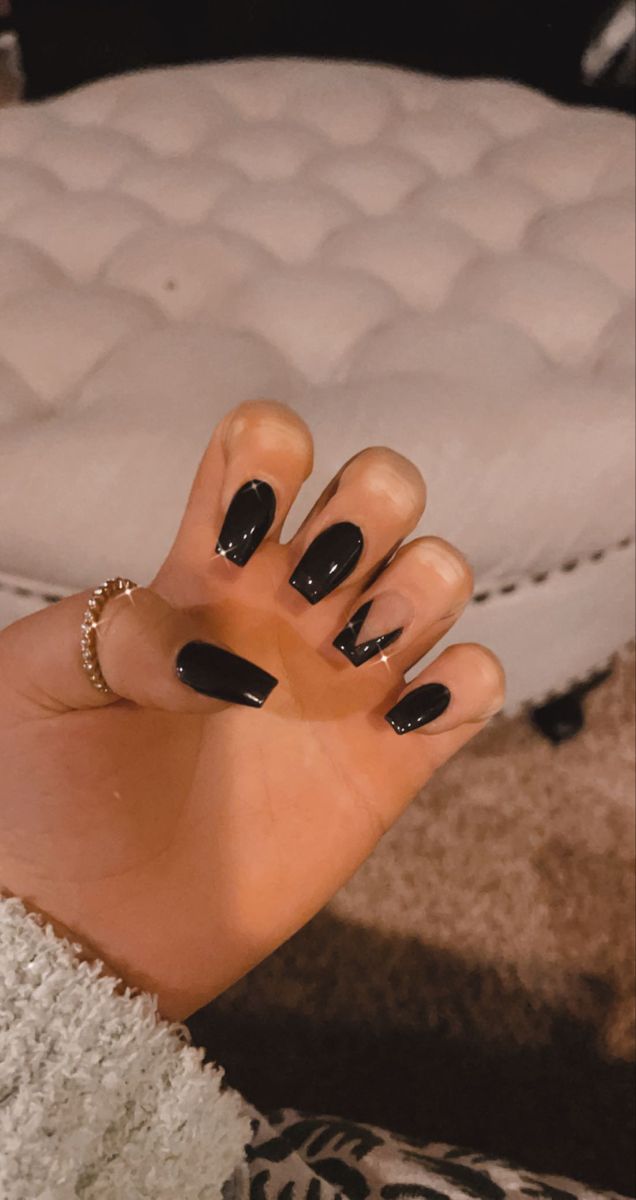 Elegant Edgy Black Nail Design: Glossy Finish with Unique Geometric Accents.