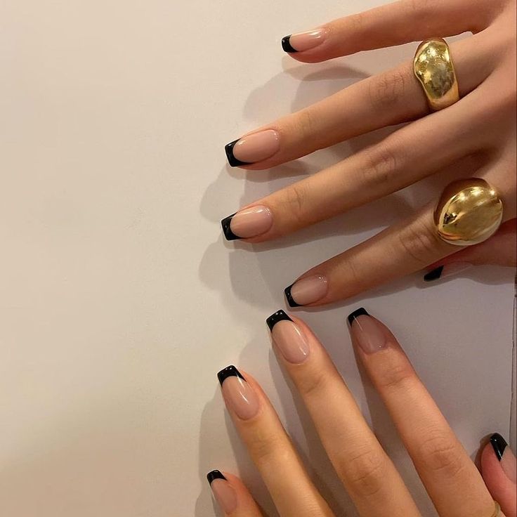 Chic Nude Nails with Bold Black Tips for a Sophisticated Edge.