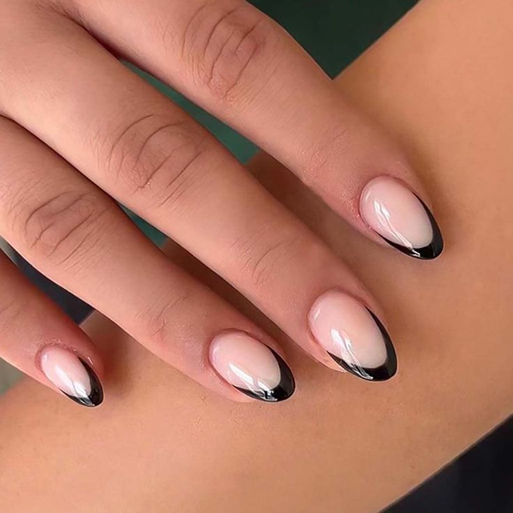 Chic Ombre Almond Nails: A Sophisticated Fusion of Soft Nude and Bold Black Tips.