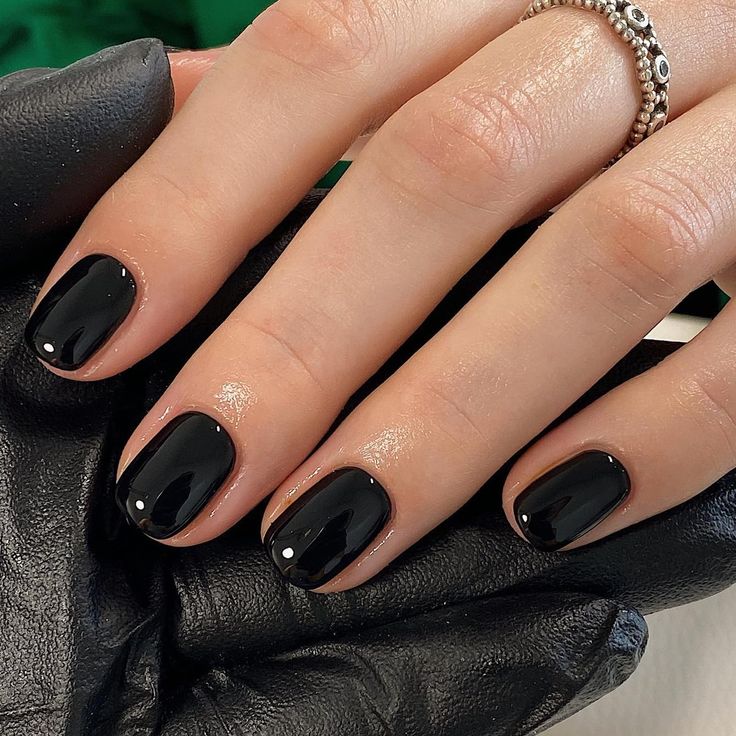 Sophisticated Elegant Black Nails with Glossy Finish and Subtle Gem Accents