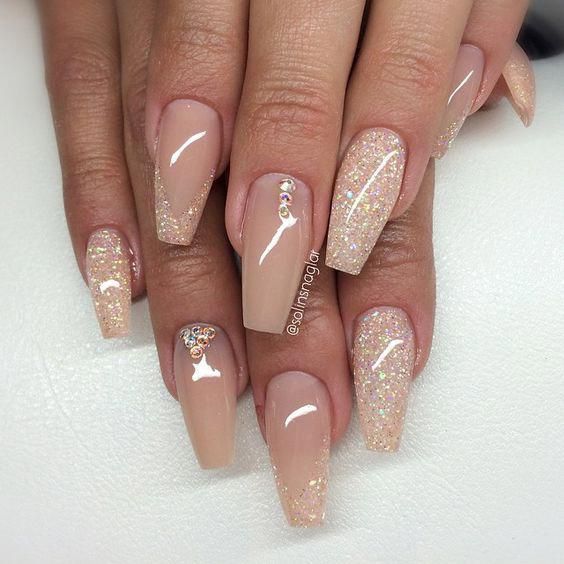 Sophisticated Elegant Nude Nails with Glossy Finish and Chic Glitter Accents.