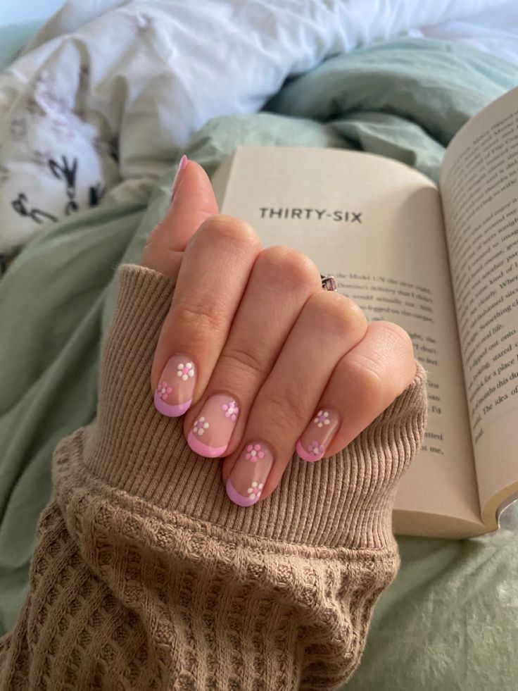 Charming Spring Floral Nail Design with Light Pink Tips and Delicate White Accents.