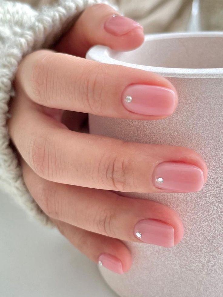 Elegant Chic Nude Nail Design with Soft Pink Base and Gemstone Accents.