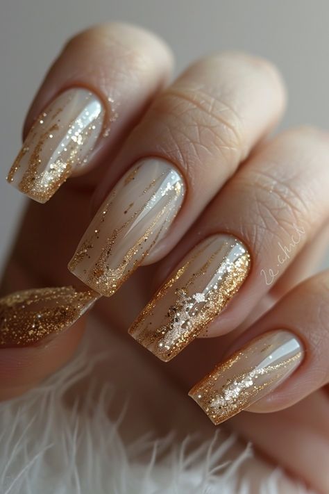 Sophisticated Nude Nails with Shimmering Gold Accents and Glitter Gradient