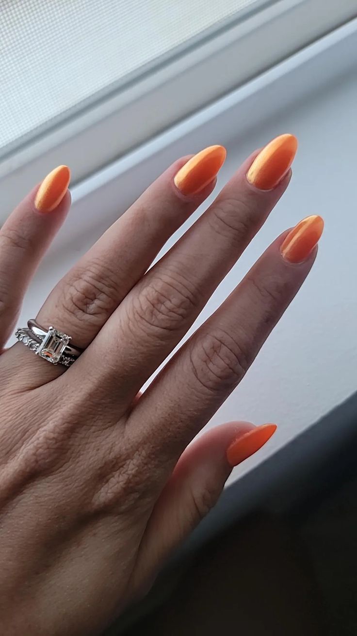 Bold Vibrant Orange Almond-Shaped Nails: A Playful Summer Statement.