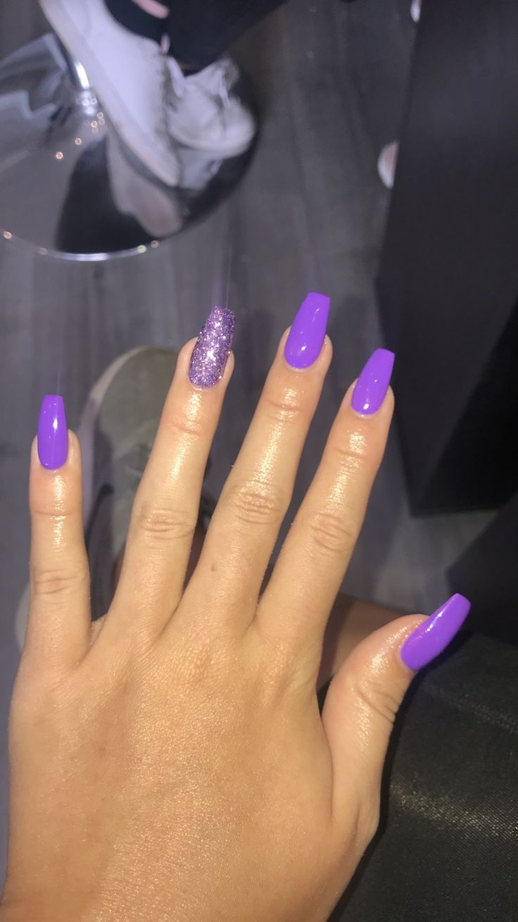 Bold Vibrant Purple Nails with Glossy and Glittery Finishes for a Trendy Look.