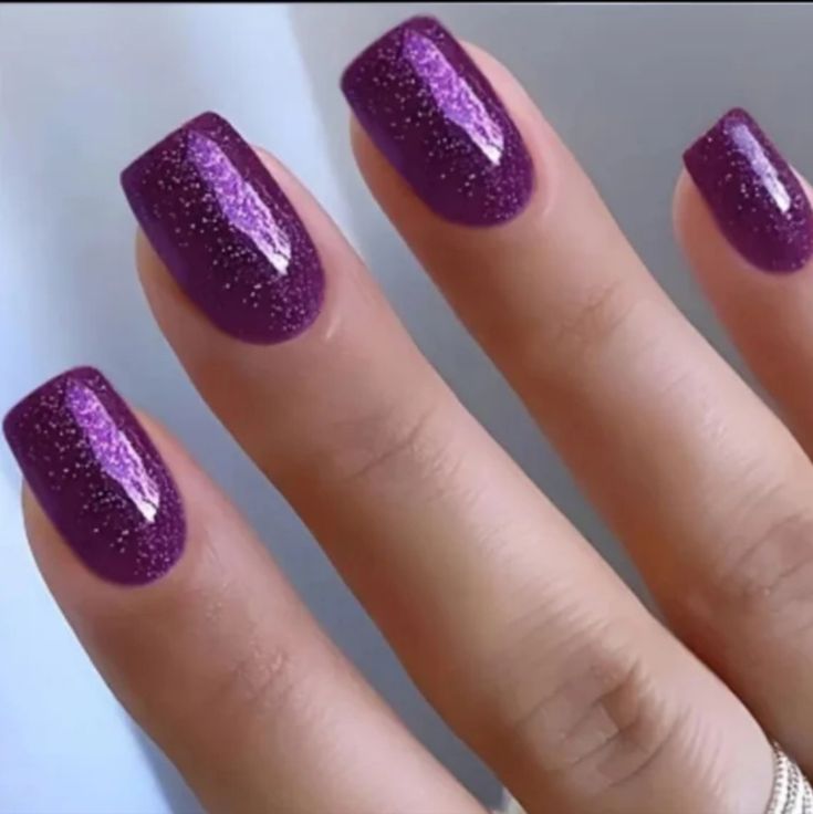 Vibrant Purple Glitter Manicure with Glossy Finish and Square Tips for Bold Style.