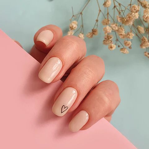 Chic Elegant Nude Manicure with Minimalist Heart Design for Any Occasion