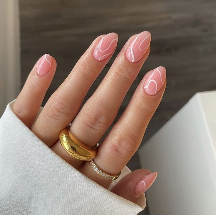 Sophisticated Almond-Shaped Nails with Soft Pink Base and Wavy White Accents.