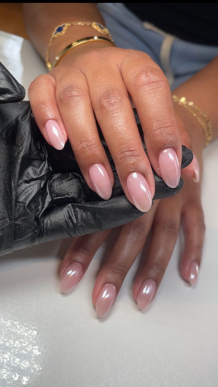 Sophisticated Almond-Shaped Nails in Delicate Nude Pink with Glossy Finish and Manicured Cuticles.