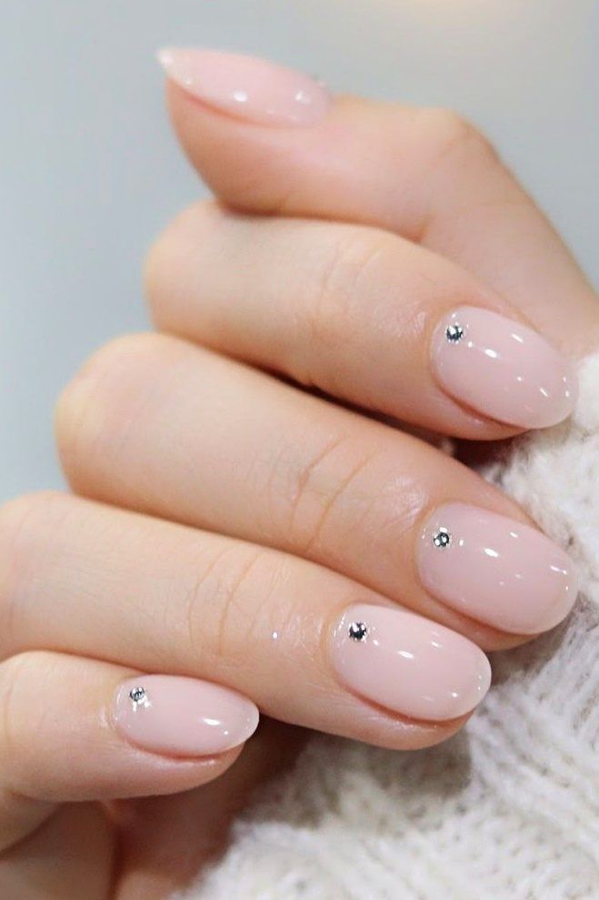 Chic Almond-Shaped Nude Nails with Rhinestones: A Sophisticated Blend of Simplicity and Glamour.