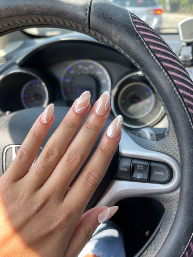 Chic Long Tapered Nails with Elegant Nude Base and Glossy White Abstract Designs.