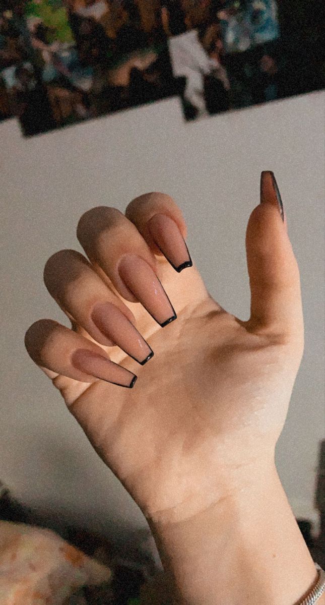 Sophisticated Almond-Shaped Nails: Nude Base with Bold Black Tips