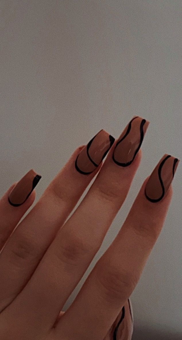 Modern Chic Manicure: Nude Base with Artistic Black Swirls.