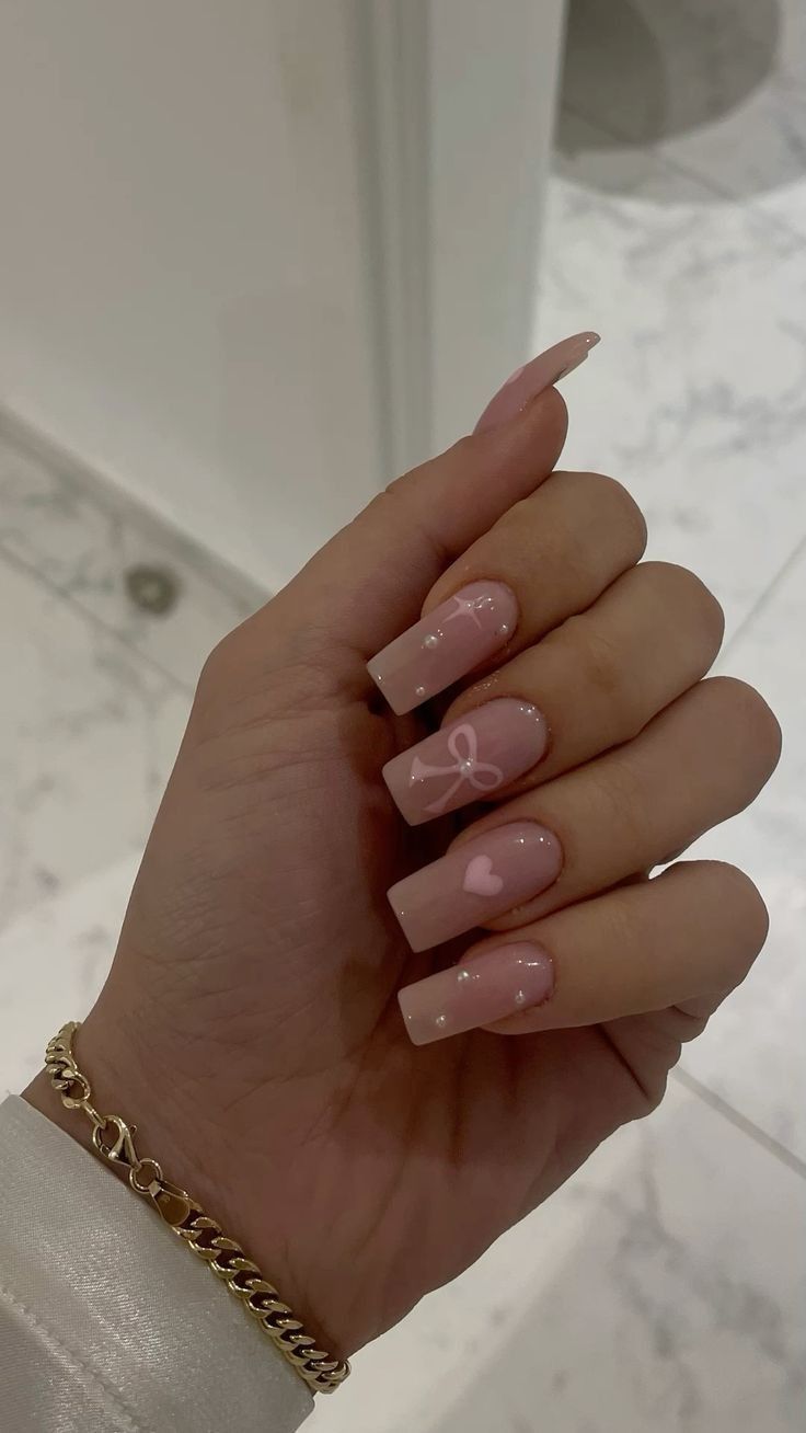 Chic Nude Nail Design with Elegant Square Tips and Playful Pink Accents