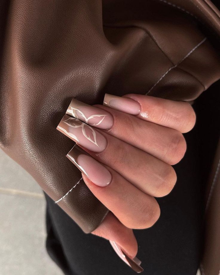 Chic Elegant Nail Design with Soft Pink and Nude Shades and Intricate Leaf Patterns