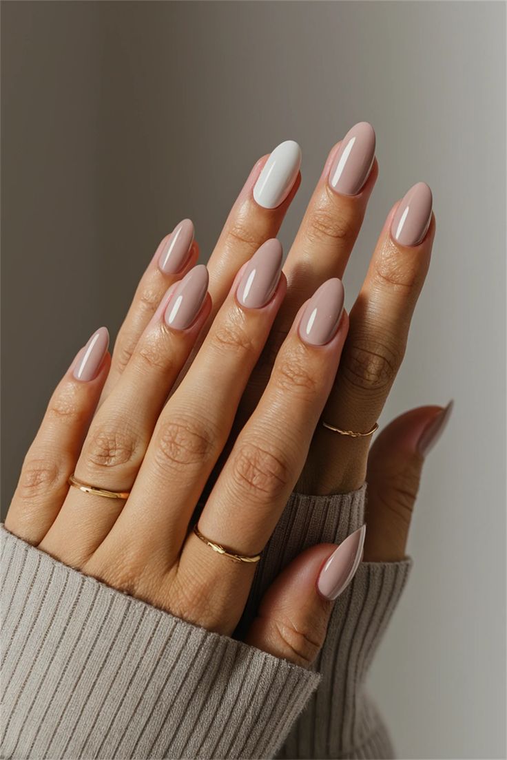 Sophisticated Almond-Shaped Nails: Chic Nude with White Accents and Glossy Finish.