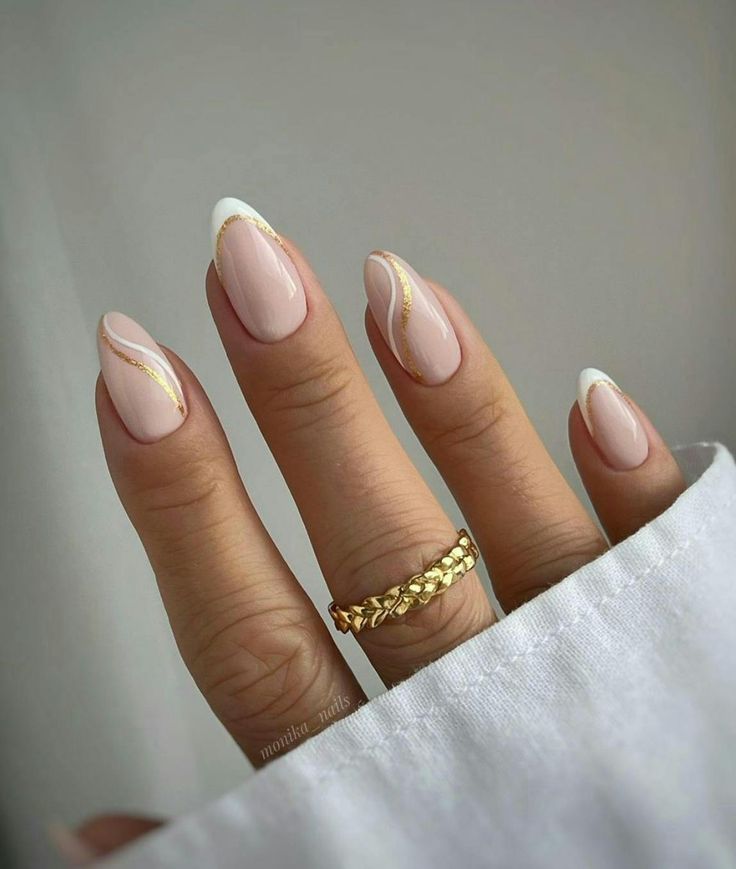 Chic Nude Nail Design with Subtle White Tips and Delicate Gold Accents.