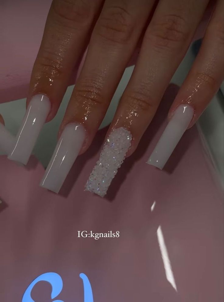 Chic Nude Long Nails with Sparkling Glitter Accent for Versatile Elegance.