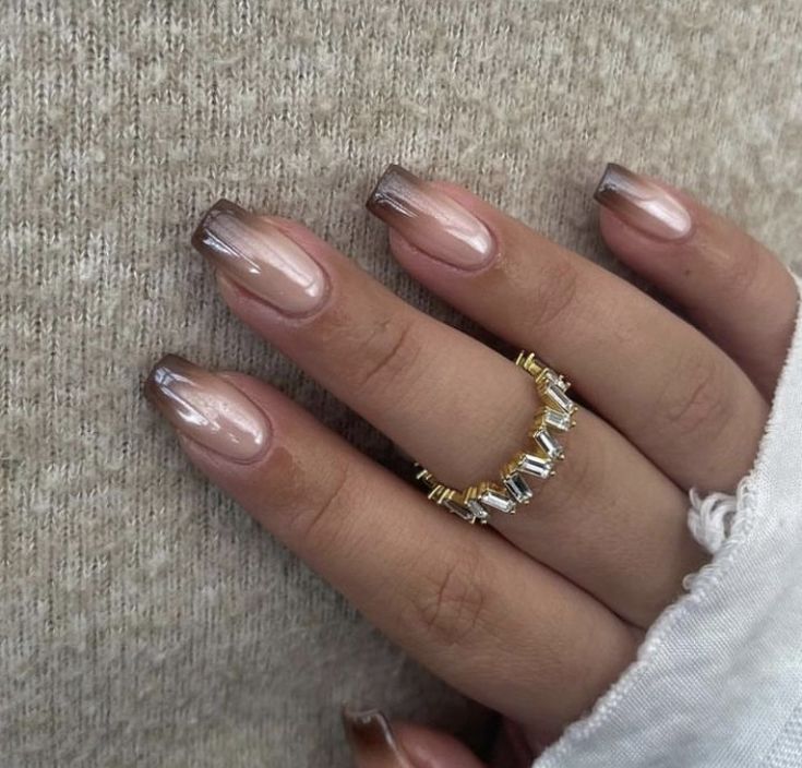 Sophisticated Ombre Nail Design with Glossy Finish and Delicate Accessories.