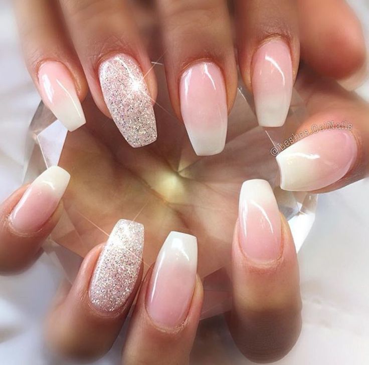 Glamorous Soft Pink Gradient Nail Design with French Tips and Sparkling Accents.